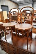 A pair of traditional bentwood bistro style chairs