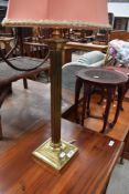 A brass table lamp having Corinthian style column