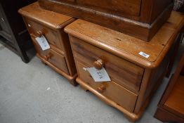 A pair of pine two drawer low bedside chests