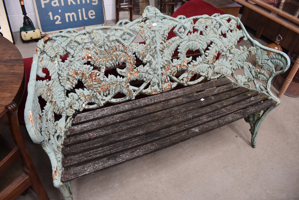 A Victorian cast iron bench in the manner of Coalbrookdale, fern and berry design, overpainted,