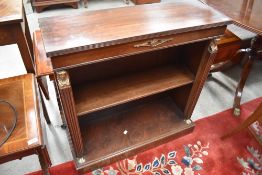 A reproduction mahogany low bookshelf having brass detailing