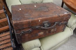 A vintage leather travel trunk, impressed marks for Pescott, Manchester, with railway labels etc
