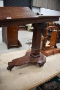 A Victorian mahogany rise and fall, adjustable music stand with two hinged platforms over the square