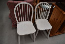 A pair of traditional painted hoop and stick back kitchen chairs