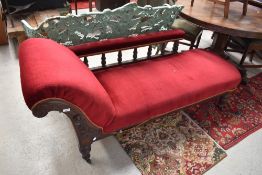 A Victorian mahogany framed chaise longue with turned rail back and red dralon upholstery