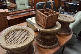 Three vintage wicker stools/occasional tables and a bottle carrier