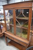 An Edwardian mahogany display cabinet on stand having glazed top with velvet lined shelves, two