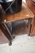 A vintage oak tea trolley with drop flaps