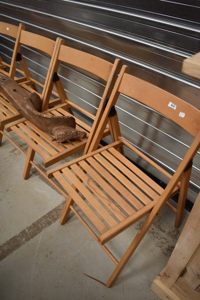 A set of four modern deck style folding chairs