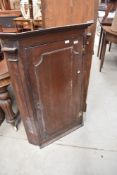 A Georgian corner cabinet with three shelves, key present.