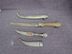 Two possibly Middle Eastern Khanjar, total length 20cm, highly decorated white metal scabbard and