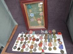 A large collection of Russian WW2 Military Medals including a framed and glazed display case of