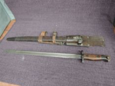 A British 1907 Bayonet by Wilkinson with various proof marks on blade, leather scabbard and frog,