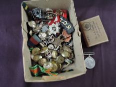 A collection of British Militaria including WW2 Medals, Buttons, Cap Badges and Cloth Badges