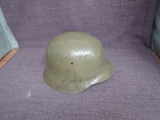 A WW2 German Helmet having leather inner liner, no marks seen, appears to have had a badge or