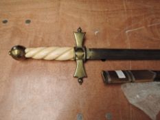 A reproduction Medievel Sword with brass crossguard with bone coloured plastic handle with brass