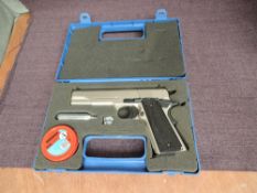 A Umerex Colt Government 1911 A-11 .177 Air Pistol in case with pellets and gas canisters,