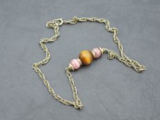 A 9ct gold rope chain necklace with central three bead panel, approx 15' & 13.4g