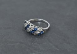 A sapphire and diamond seven row dress ring, total approx 1ct, having claw set panel mount on a
