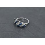 A sapphire and diamond seven row dress ring, total approx 1ct, having claw set panel mount on a