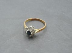 A sapphire and diamond chip cluster ring having an illusionary mount on an 18ct gold loop, size Q/