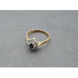 A sapphire and diamond chip cluster ring having an illusionary mount on an 18ct gold loop, size Q/