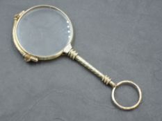 A yellow metal lorgnette of traditional form, spring working, no marks