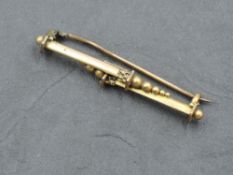 A 9ct gold bar brooch, pillar and ball design, marked 9ct, 4cm, 2.1grams