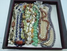 A selection of vintage strings of beads including mother of pearl, polished mineral, glass,