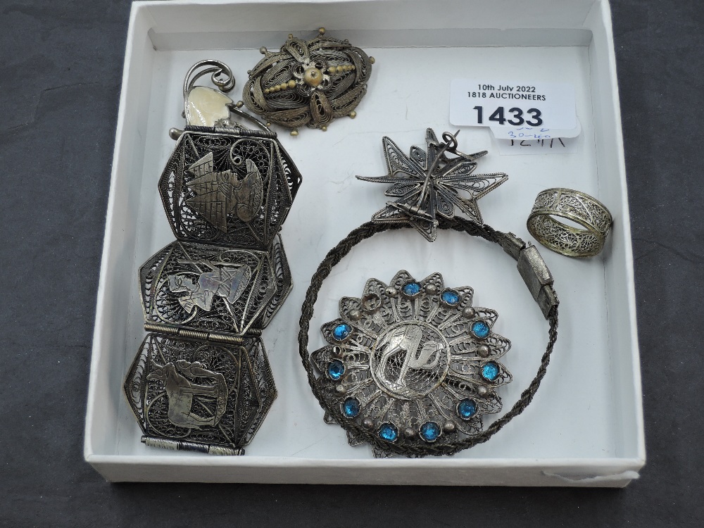 A selection of white metal filigree jewellery, comprising bracelets, brooches and one ring,