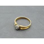 A diamond solitaire dress ring, approx 0.065ct in an illusionary mount to moulded shoulders on a