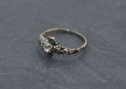 A Georgian diamond ring having a central rose cut diamond within a a surround of six further small