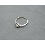 A diamond solitaire ring of dainty form, approx 0.25ct in a raised claw mount having diamond set