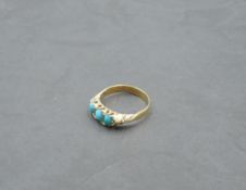 A Victorian ring having a trio of oval turquoise in a gallery mount on a yellow metal loop, marks
