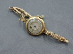 A 1930's 18ct gold cased ladies wristwatch, with Arabic hours to the silvered dial, the case