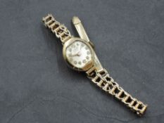 A lady's vintage 9ct gold wrist watch by Tudor having Arabic numeral dial to small face in gold case