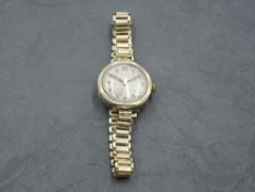 A lady's vintage 9ct gold Rolex wrist watch having Arabic numeral dial to engine turned face in gold