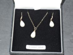 A 9ct gold and simulated teardrop pearl pendant and chain with matching drop loop earrings