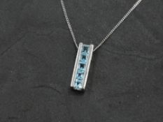 A 9ct white gold pendant and chain having blue paste stones in channel setting, approx 3g