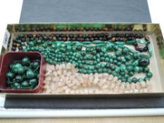 Seven strings of polished stone beads including tigers eye, malachite and rose quartz