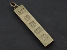 A 9ct gold ingot pendant having over sized hallmark decoration, approx 30.6g