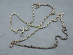 A yellow metal fancy link muff chain with dog leash clasp, no marks but tests as 9ct gold, approx