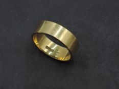 A gent's yellow metal wedding band stamped 8ct and bearing hallmarks, probably Australian, size