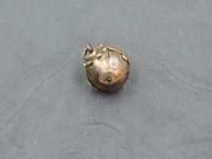 A yellow and white metal Masonic ball pendant, of traditional form with locking straps, marks