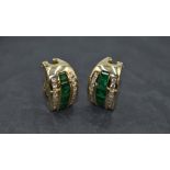 A pair of emerald and diamond stud earrings having a central row of baguette cut emeralds flanked by