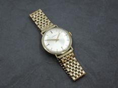 A gent's 9ct gold wrist watch by Mondia having a baton numeral dial to silvered face in a 9ct gold