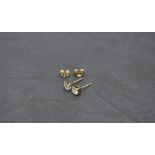 A pair of 9ct gold solitaire stud earrings, one having a diamond, approx 0.3ct, the other having a