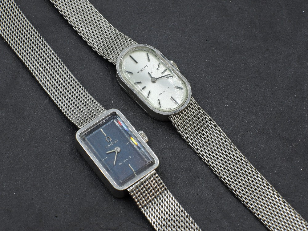 A lady's Omega De ville steel wrist watch having plain navy face in rectangular case on steel