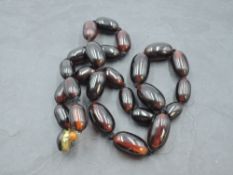 A knotted string of graduated cherry amber beads approx 74g & 24' long