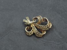 A 9ct gold brooch, of scrolling bouquet design with filigree decoration, marked .375, 2.5cm, 2.